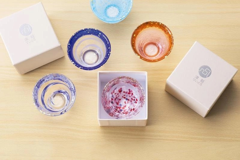 Aderia, A sake cup with gold foil on the rim and pink and white spots on the bottom